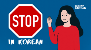 A stop sign and a woman doing the stop gesture